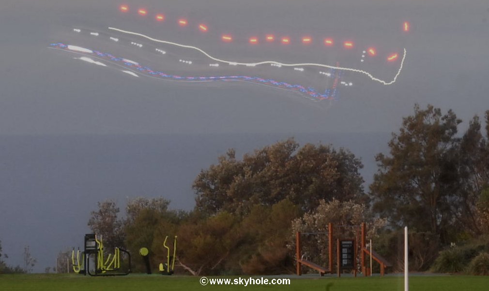 This photo show a different aspect of the extented helicopters light trail with the identifying blue and red police lights at the bottom of the light show.

Also a close up of some of the exercising equipment in the park.